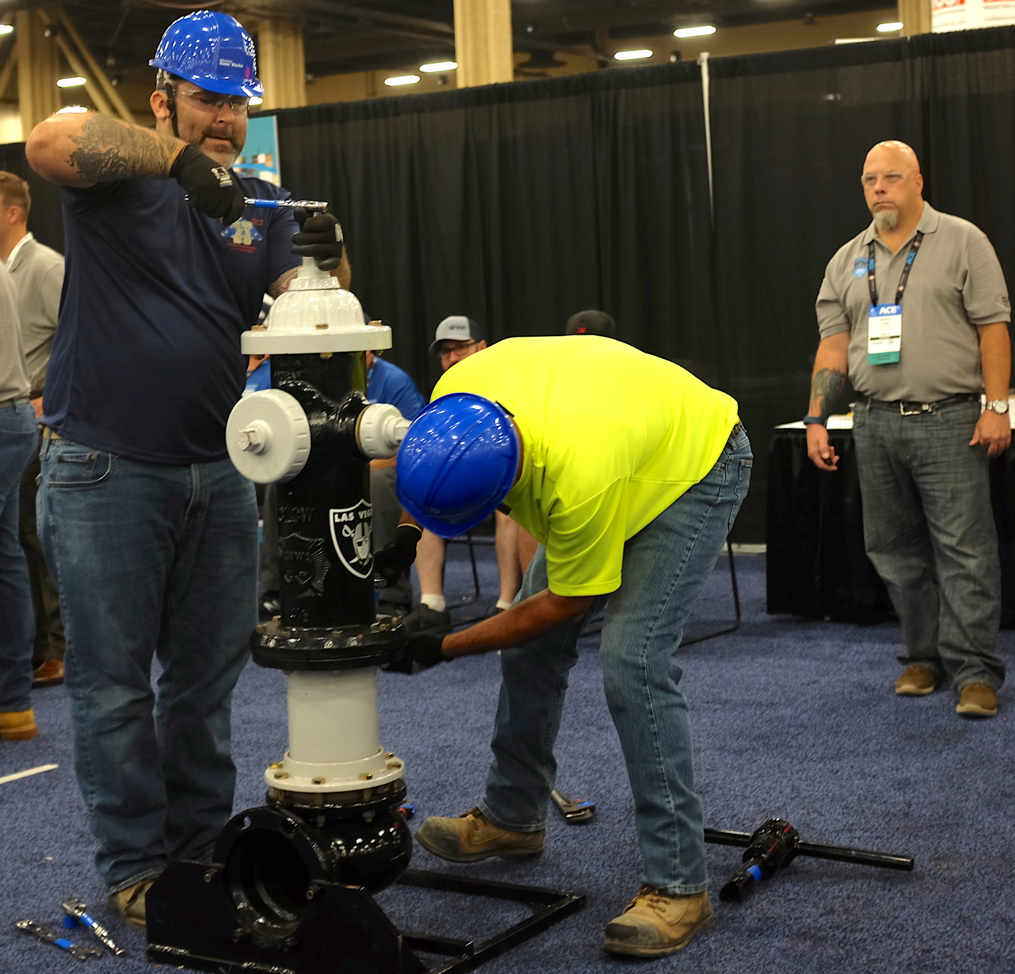 Workers from the city of Milwaukee participate in the Hydrant Hysteria competition to assemble a hydrant as quickly as possible