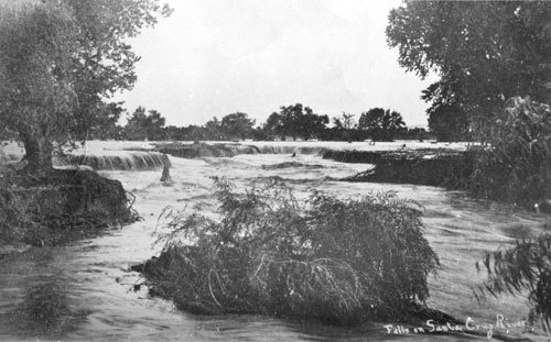 This is an old photograph showing waterfalls along the Santa Cruz River in downtown Tucson in 1889.
